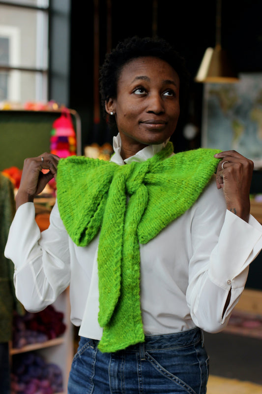 Ashley models a bright green bow knit from new pattern, The Party Bow.